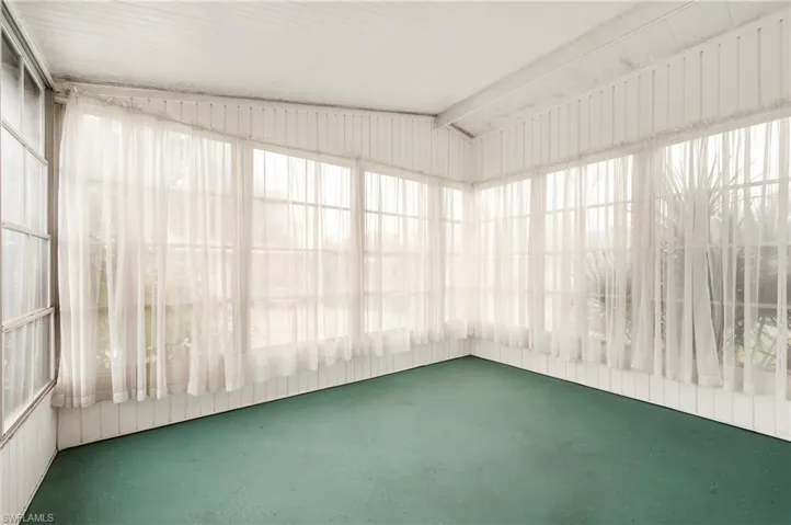 Unfurnished sunroom with vaulted ceiling