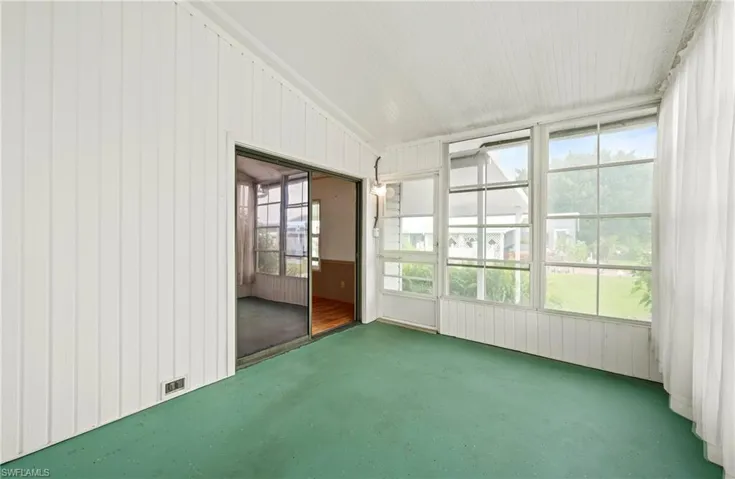 Unfurnished sunroom with vaulted ceiling