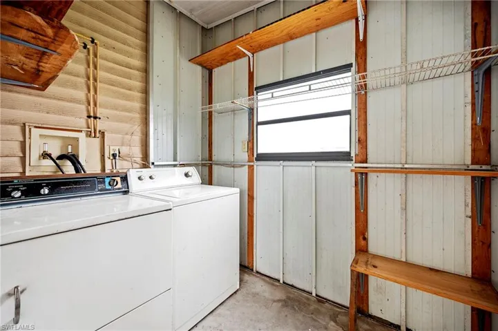 Washroom with washer and clothes dryer