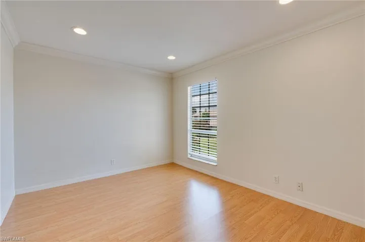 Room featuring light wood-finish flooring, recessed lighting, and crown molding