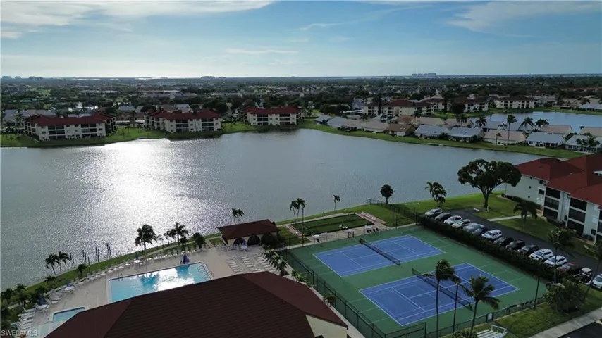 Drone / aerial view of a large body of water and a pool