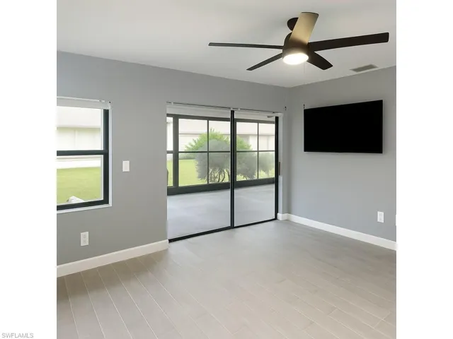 Unfurnished room with light wood finished floors and a ceiling fan