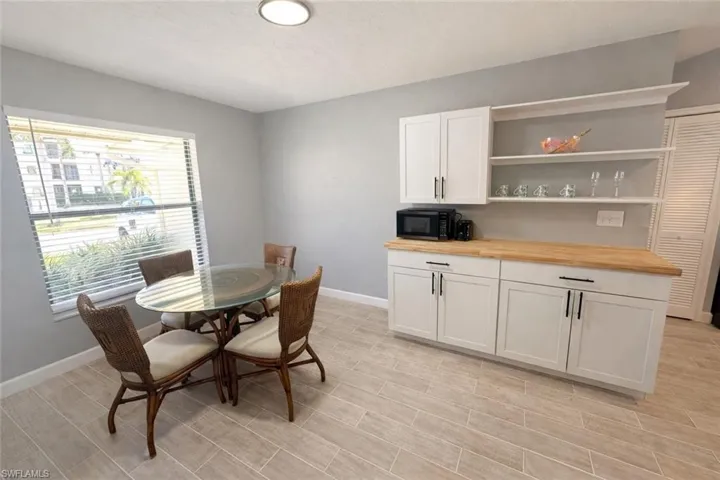 Dining room with a textured ceiling and wood tiled floors