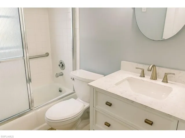 Full bathroom with shower / bath combination with glass door and vanity