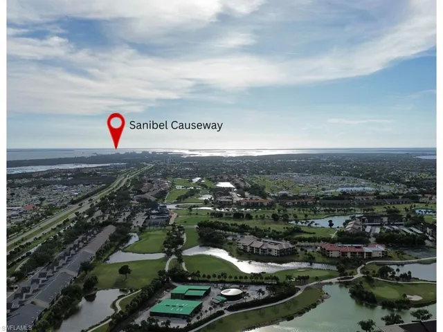 Aerial view of property's location with a nearby body of water and nearby suburban area