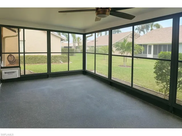 Unfurnished sunroom with healthy amount of natural light and ceiling fan