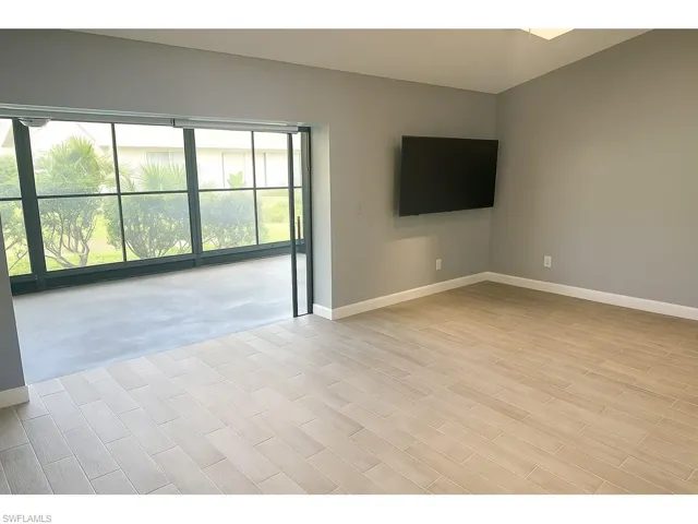 Empty room with baseboards and light wood finished floors