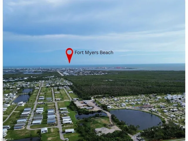 View of property location with a large body of water and nearby suburban area