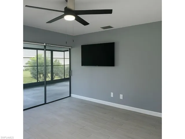 Spare room with a ceiling fan and light wood-style floors