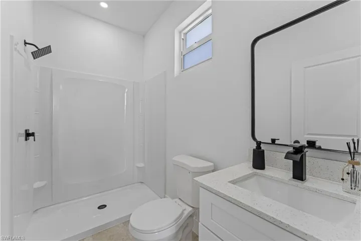 Bathroom featuring vanity and a shower stall