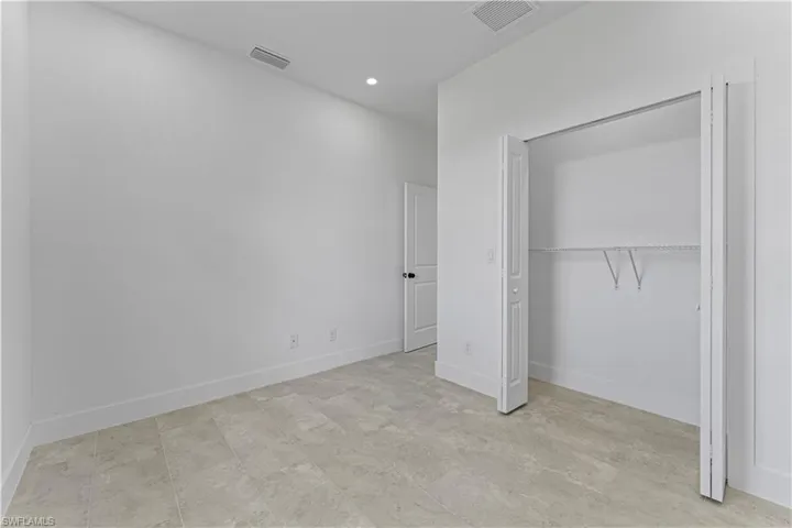 Unfurnished bedroom with a closet and recessed lighting