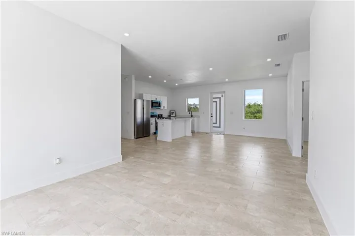 Unfurnished living room with recessed lighting