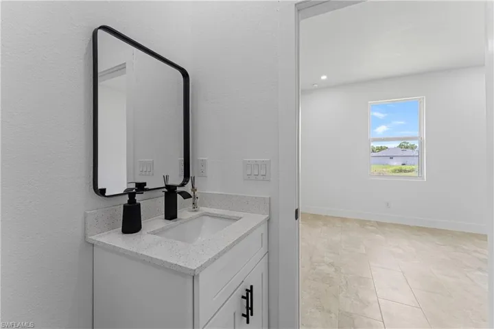 Bathroom with vanity and light tile patterned flooring