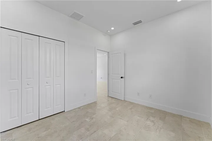 Unfurnished bedroom featuring recessed lighting and a closet