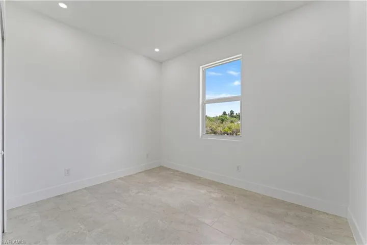 Spare room with baseboards and recessed lighting