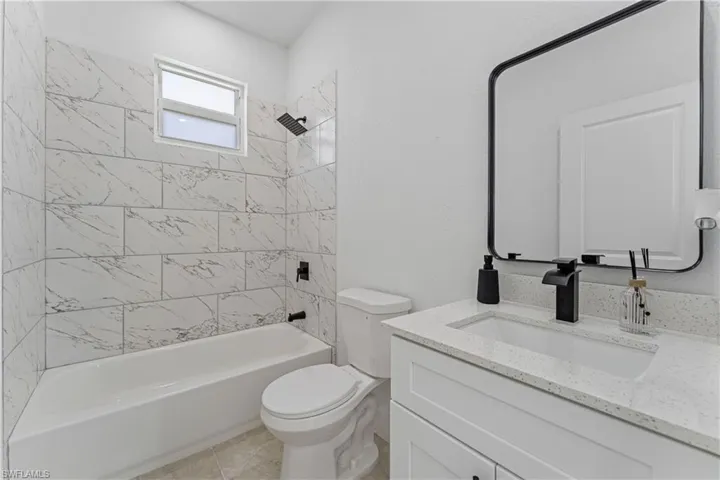 Full bathroom with shower / washtub combination and vanity