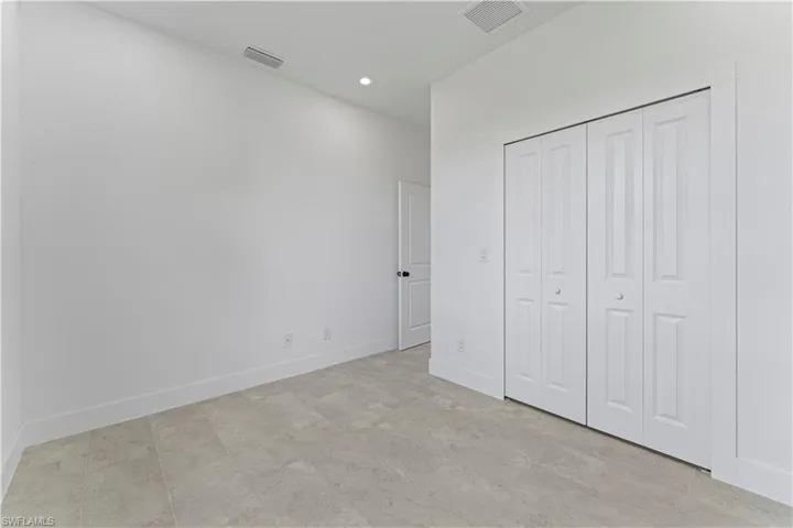 Unfurnished bedroom featuring recessed lighting and a closet