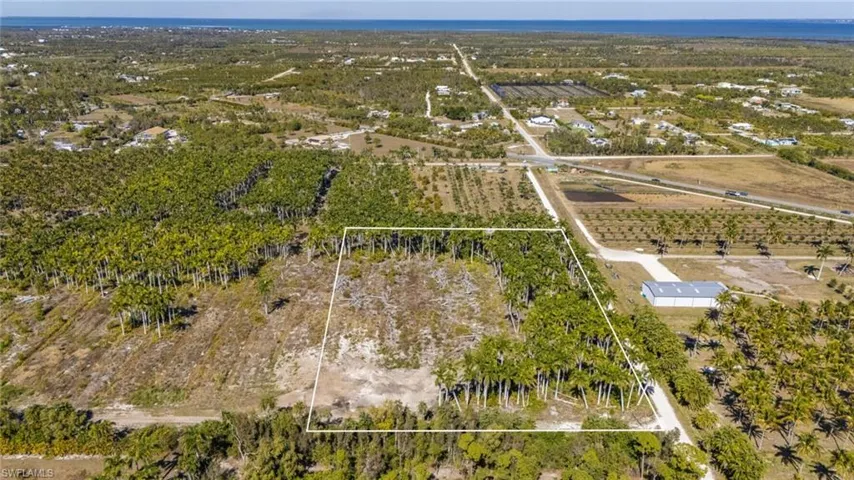 Aerial view of property's location featuring rows of crops, rural landscape, and property boundaries highlighted
