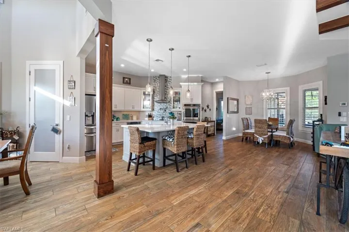 Dining space with a notable chandelier, baseboards, visible vents, light wood-style floors, and recessed lighting