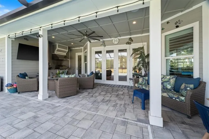 View of patio with french doors, a ceiling fan, area for grilling, and an outdoor living space