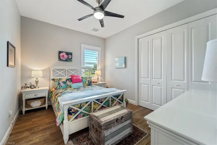 Bedroom 2with a closet, dark wood-style floors, baseboards, and visible vents