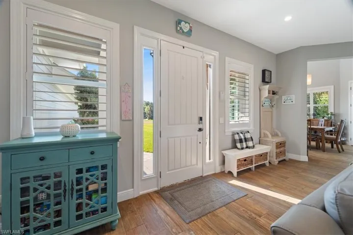 Foyer entrance featuring baseboards, light wood-style flooring, and recessed lighting