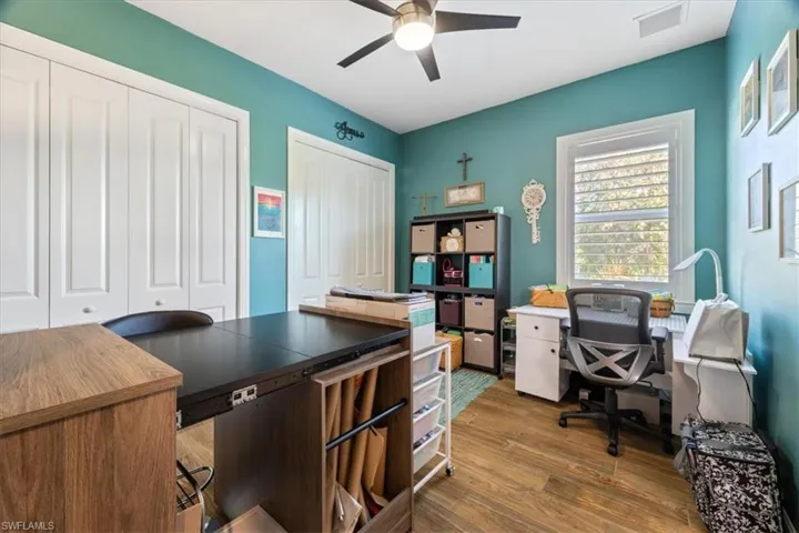 bedroom 3 with visible vents, ceiling fan, and wood finished floors
