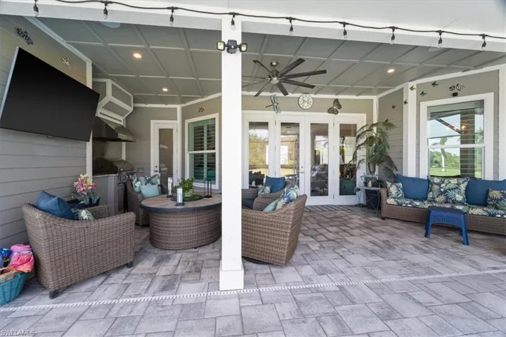 View of patio / terrace featuring french doors, a ceiling fan, an outdoor hangout area, and a grill