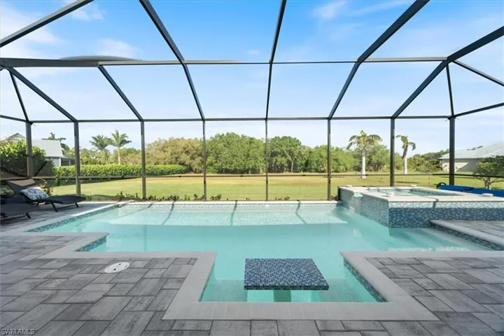 View of swimming pool with a lawn, a lanai, and a patio area