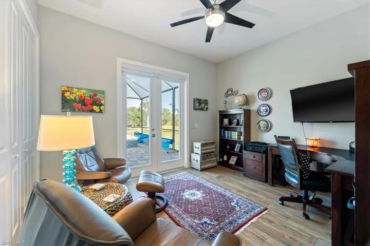 Office space with light wood-style flooring, walk out to pool, ceiling fan, and french doors