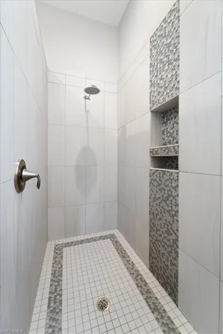 Bathroom featuring tiled shower