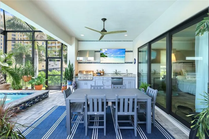 Sunroom featuring ceiling fan and sink