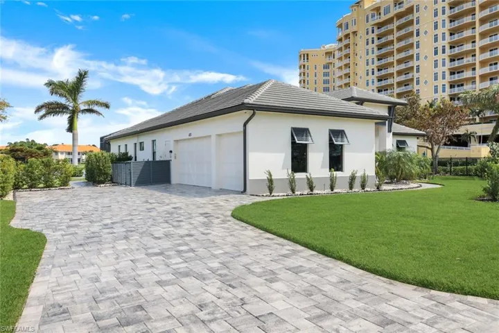 View of side of home with a garage and a yard