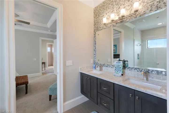 Bathroom featuring vanity and tiled shower