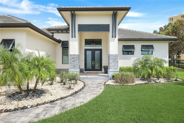 Property entrance with french doors and a yard