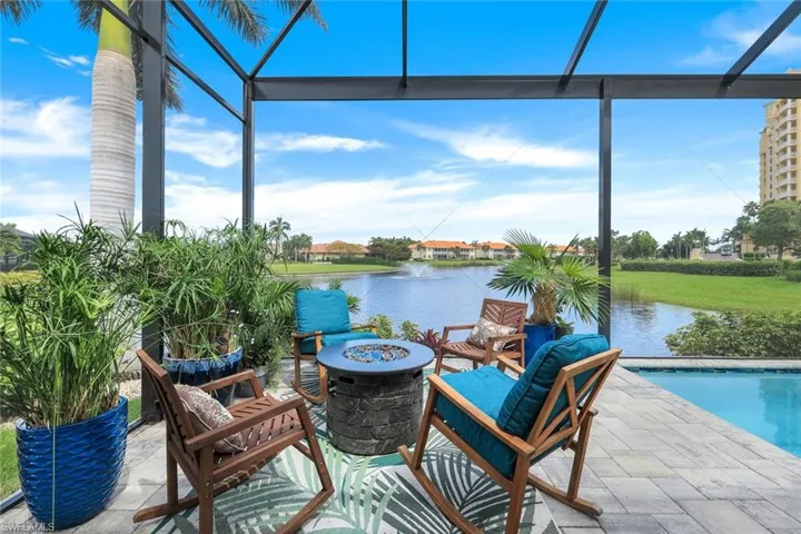 View of patio with a water view and an outdoor fire pit