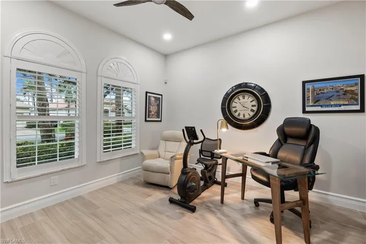 Living area with light wood-type flooring and ceiling fan