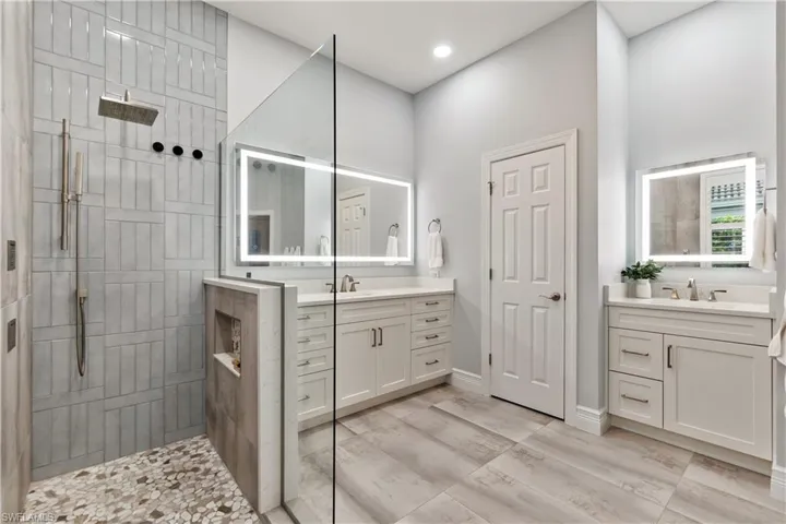 Bathroom featuring vanity and tiled shower