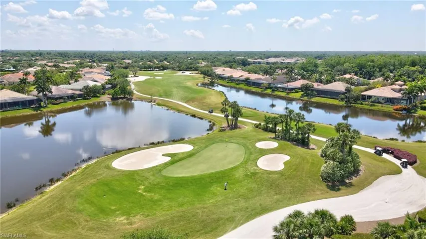 Drone / aerial view featuring golf course view and a water view
