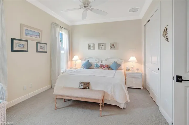 3rd ensuite bath Bedroom featuring crown molding, baseboards, light carpet, and ceiling fan, the ensuite  bathroom serves also as pool bath