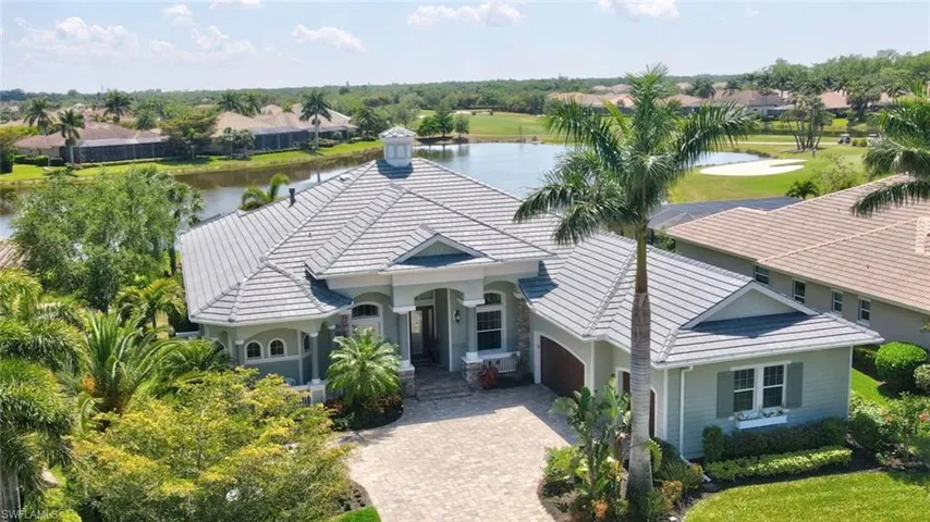 Birds eye view of property featuring a lake and golf course view