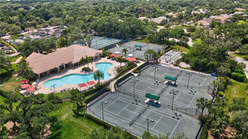 Drone / aerial view of community pool, tennis and pickleball courts