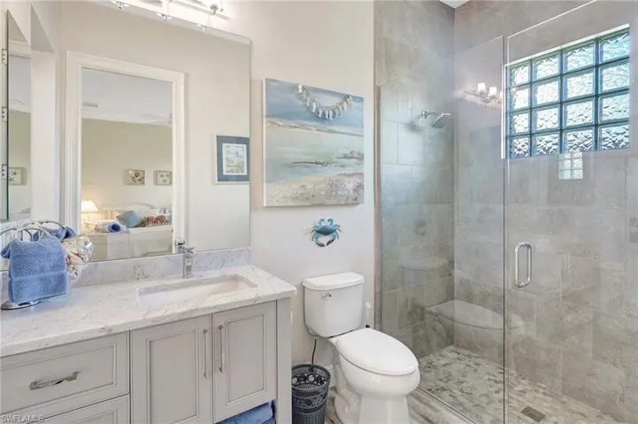 Bathroom featuring frameless stall shower, ensuite bath that serves as the pool bath as well
