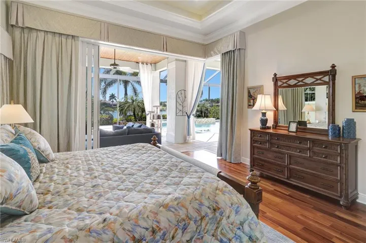 Bedroom with baseboards, crown molding, access to exterior, and wood finished floors