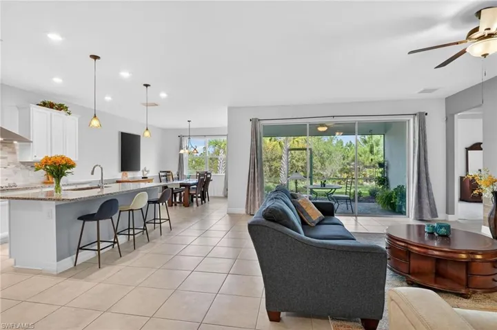 Experience the charm of this wonderful room, offering a captivating view of the kitchen dining area and access to a cozy covered lanai, perfect for enjoying leisurely moments or entertaining friends!