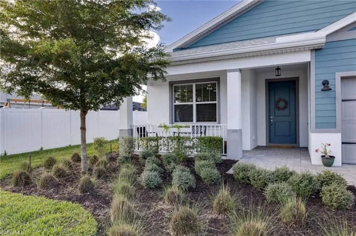 Step onto a charming, covered porch that welcomes you home, complemented by a lush front yard that adds to the inviting atmosphere.