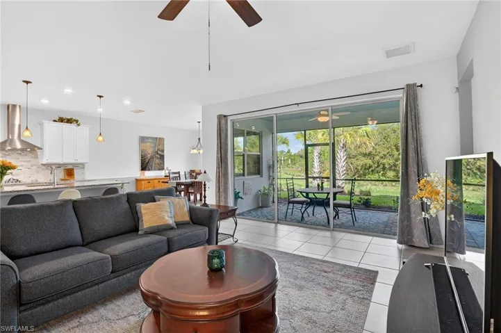 Great room with recessed lighting, showcasing a picturesque view of the inviting lanai. It's the ideal space to relax and unwind! picturesque view overlooking the inviting lanai. It's the perfect space to relax and unwind!