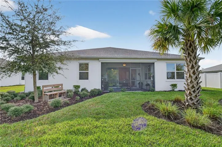 Back of the home with a bench to watch the sunset in the privacy of your own retreat