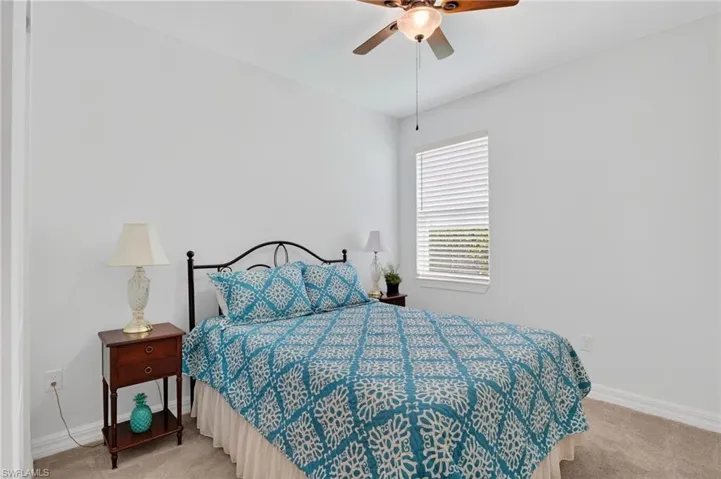 Step into the Spacious Bedroom, where cozy carpet floors invite you to relax and unwind, all while a gentle ceiling fan creates a soothing breeze.