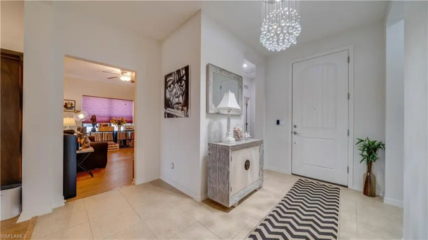 Entryway with suspended lighting, light tile patterned flooring, and ceiling fan
